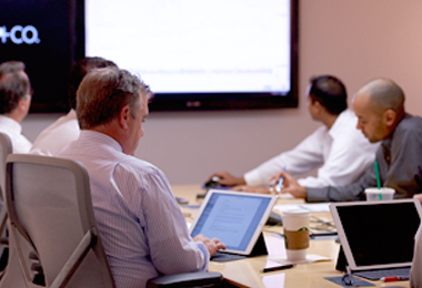 A group of people in a conference room during a meeting.