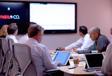 A group people in a conference room meeting.