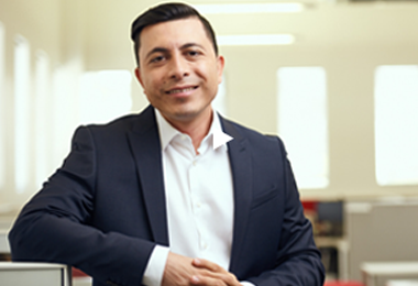A corporate photograph of research analysis director Romeo Alvarez.