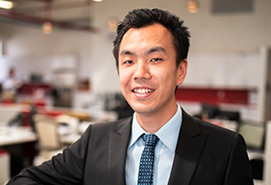 A corporate photograph of research manager Sean Li.