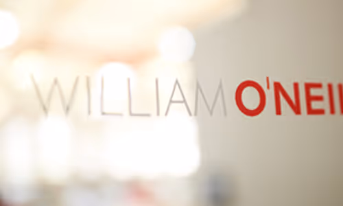 A close up image of the William O'Neil Logo on a glass door.