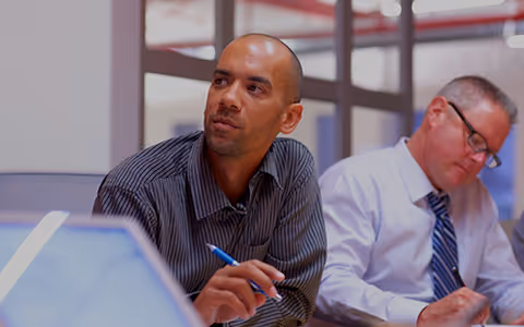Am image of two William O'Neil team members in a meeting.