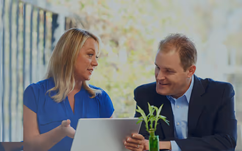 An image of two William O'Neil client support team members discussing work.
