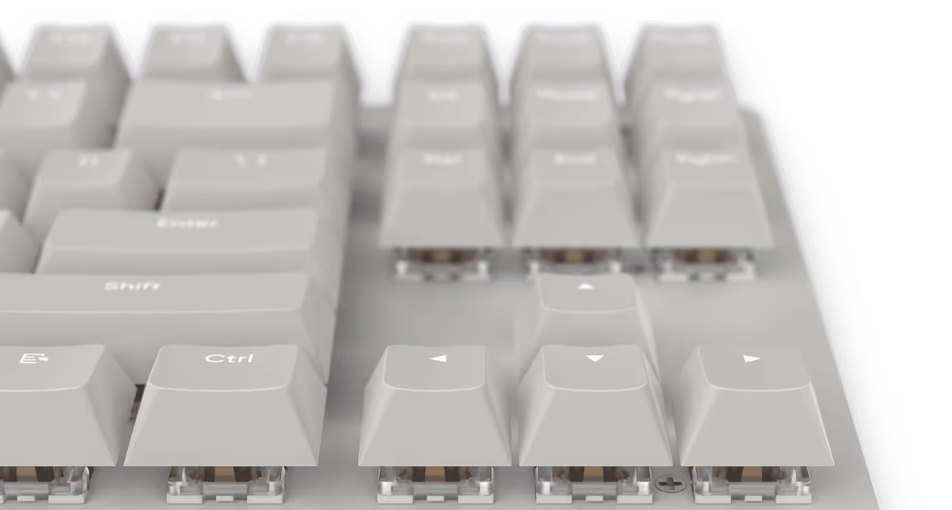 Close-up view of a white mechanical keyboard's Ctrl, Shift, and arrow keys.