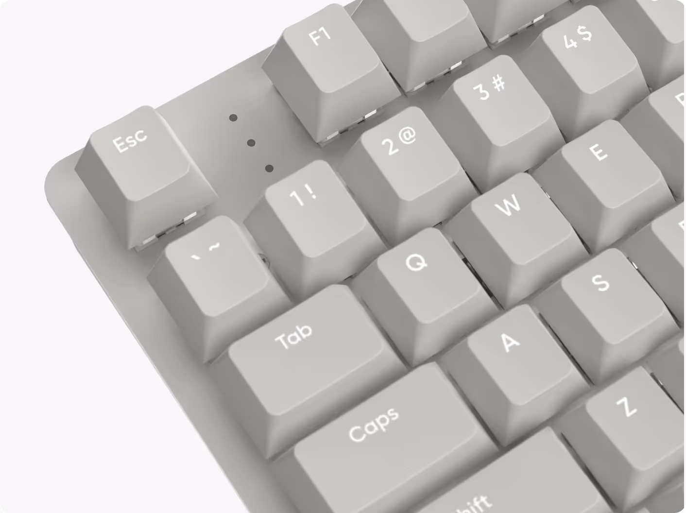 Close-up of white mechanical keyboard keys including Esc, F1, Tab, Caps, and letter keys Q, W, E, A, S, Z.