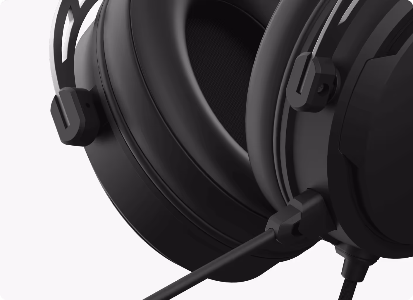 Close-up of black over-ear headphones showing cushioned ear pads and attached cable.