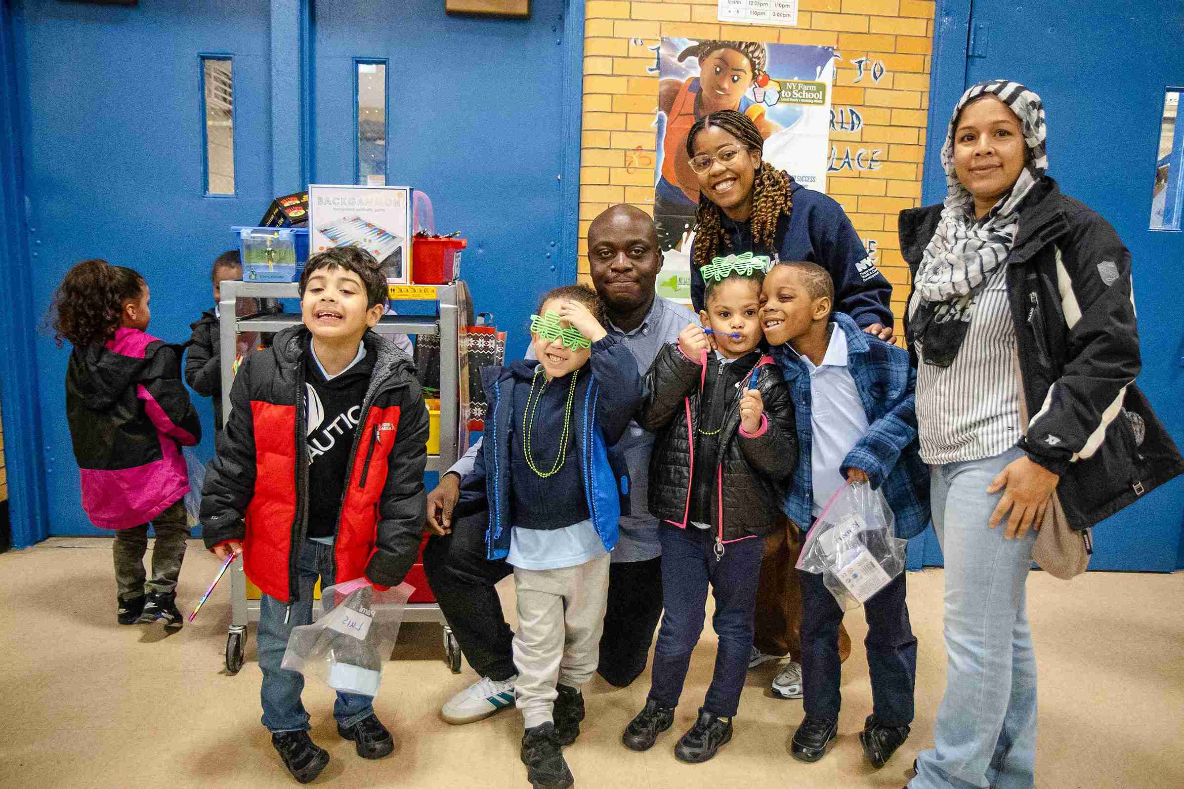 Students and adults smiling together at a school event