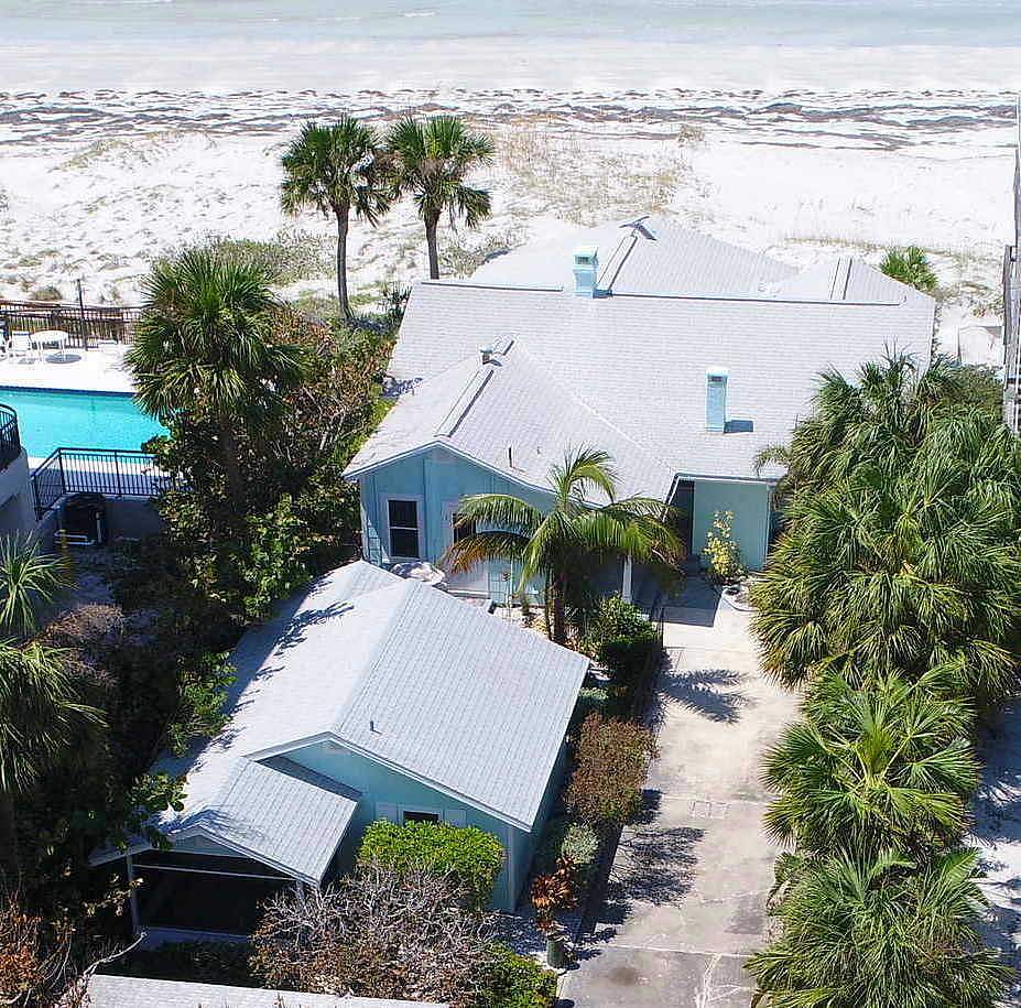 Beachfront house with roof design and ocean backdrop