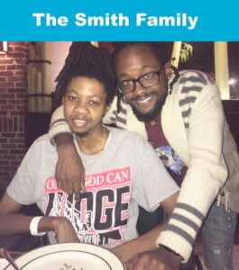 The Smith Family smiling together at dinner
