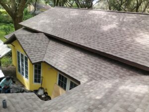 Yellow home with light brown asphalt shingle roof installation