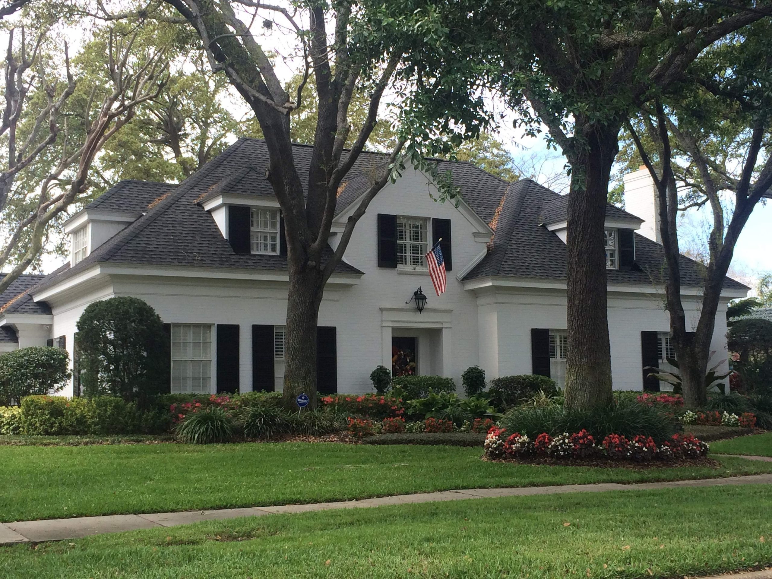 stately white home with new roof installed by roofing company Tampa