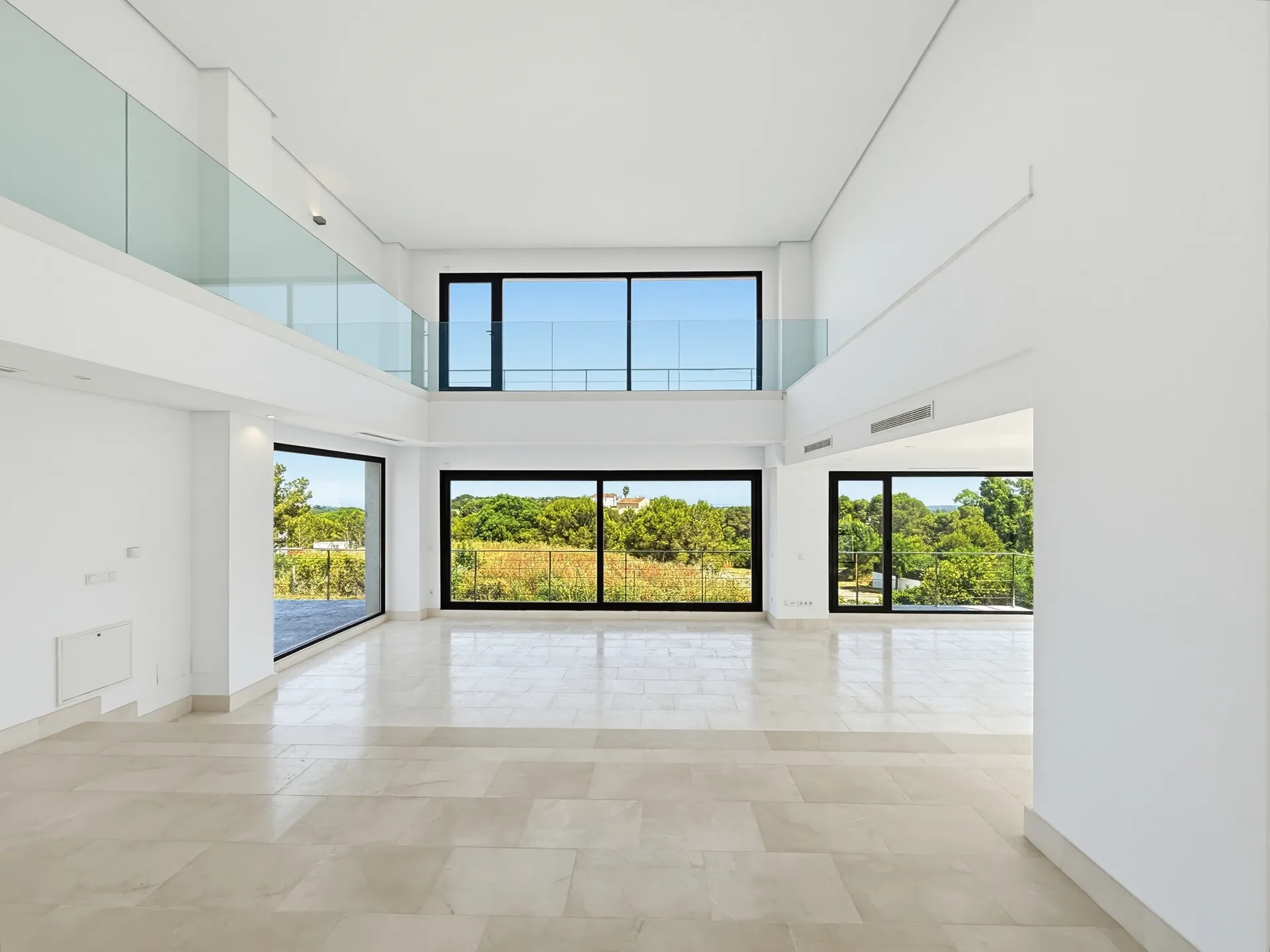 Bright unfurnished interior room with large windows and renovation potential