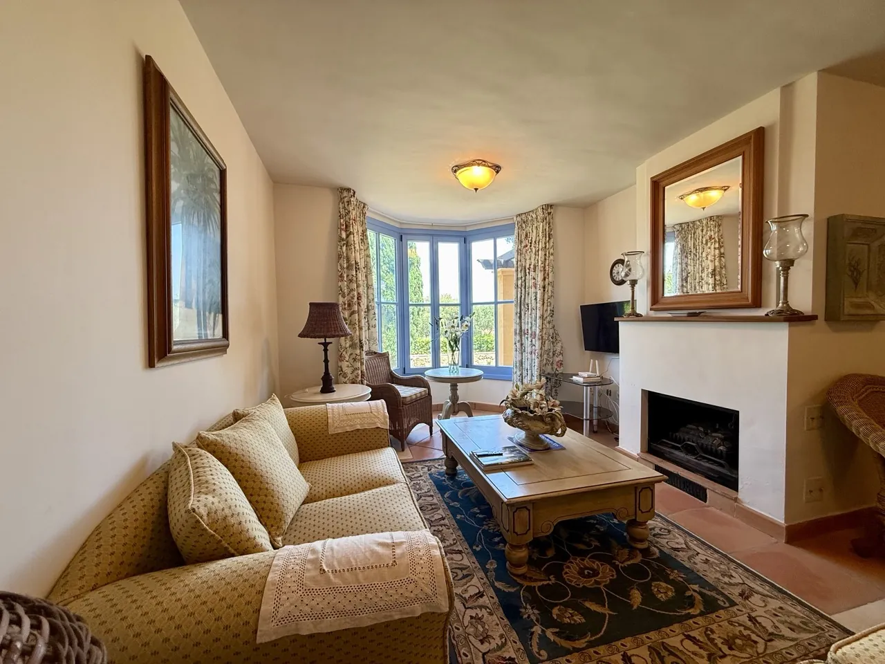 Living room with sofa seating, fireplace and natural light