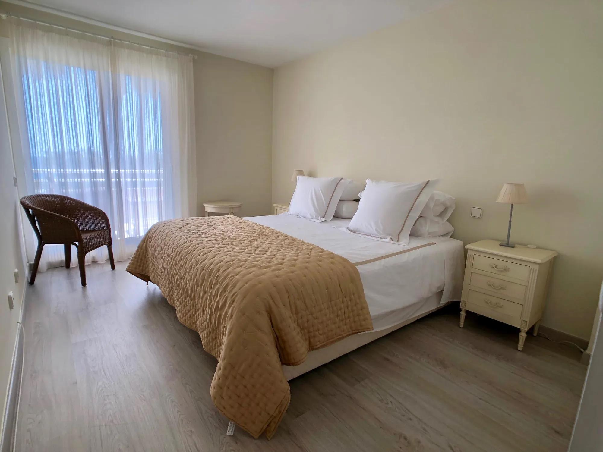 Bedroom with double bed, wooden flooring and soft natural light