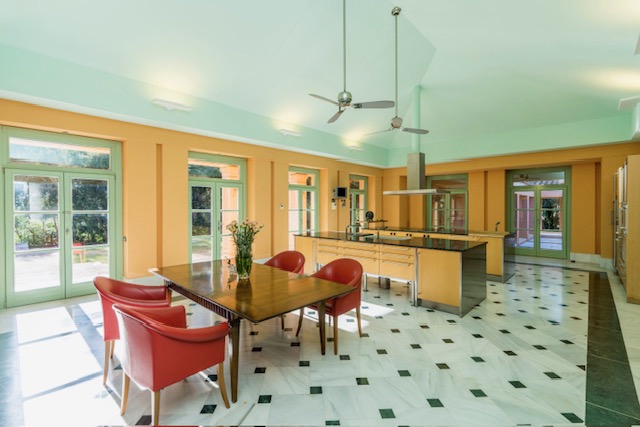 Kitchen and dining area with island and red dining chairs