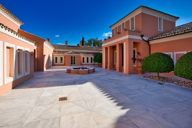 Villa courtyard exterior with terracotta façade and paved entrance area