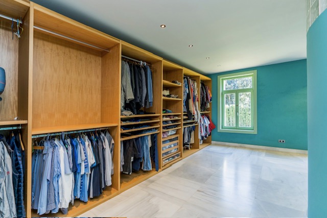 Walk-in wardrobe with open shelving and hanging space