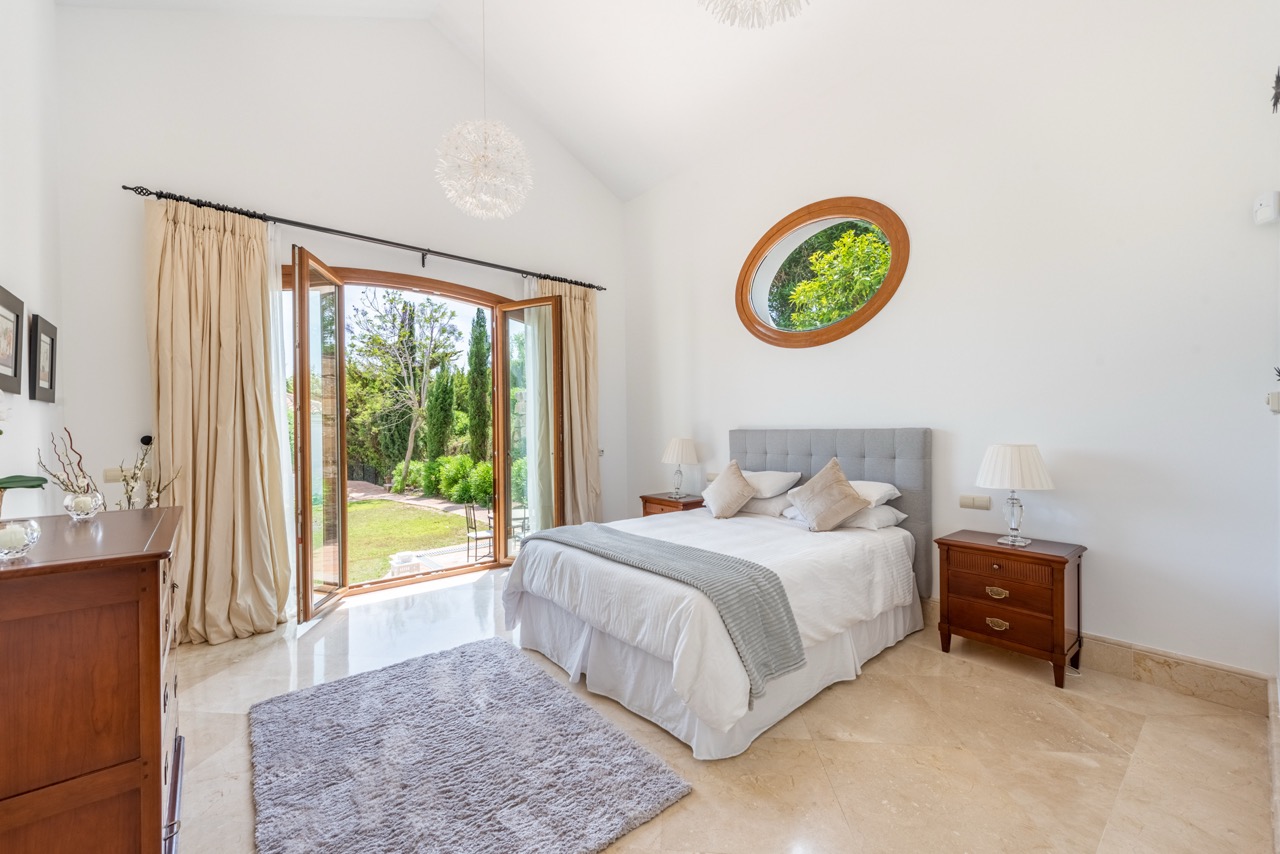 Bedroom with double bed, garden doors and traditional decor