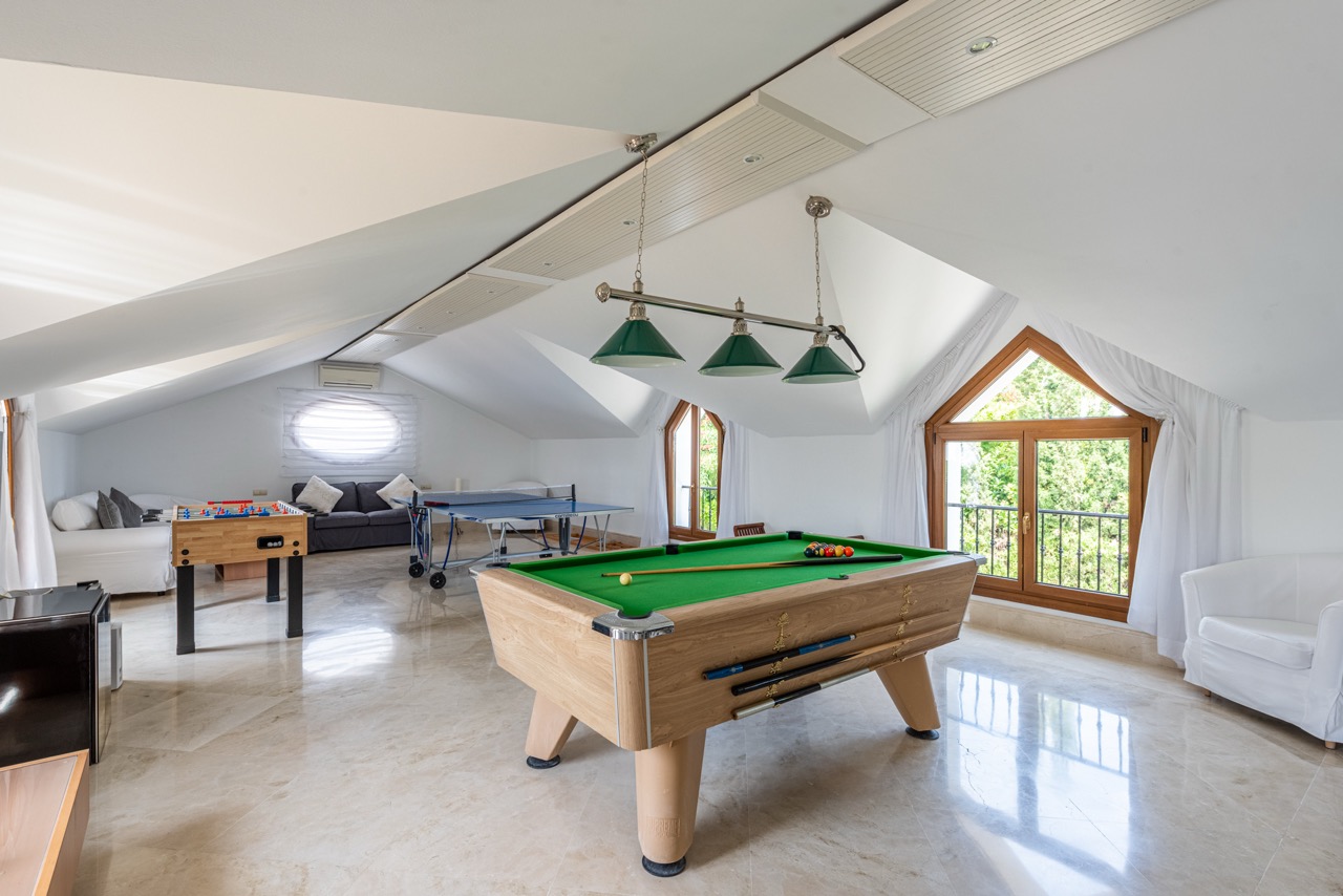 Games room with pool table, vaulted ceiling and large windows