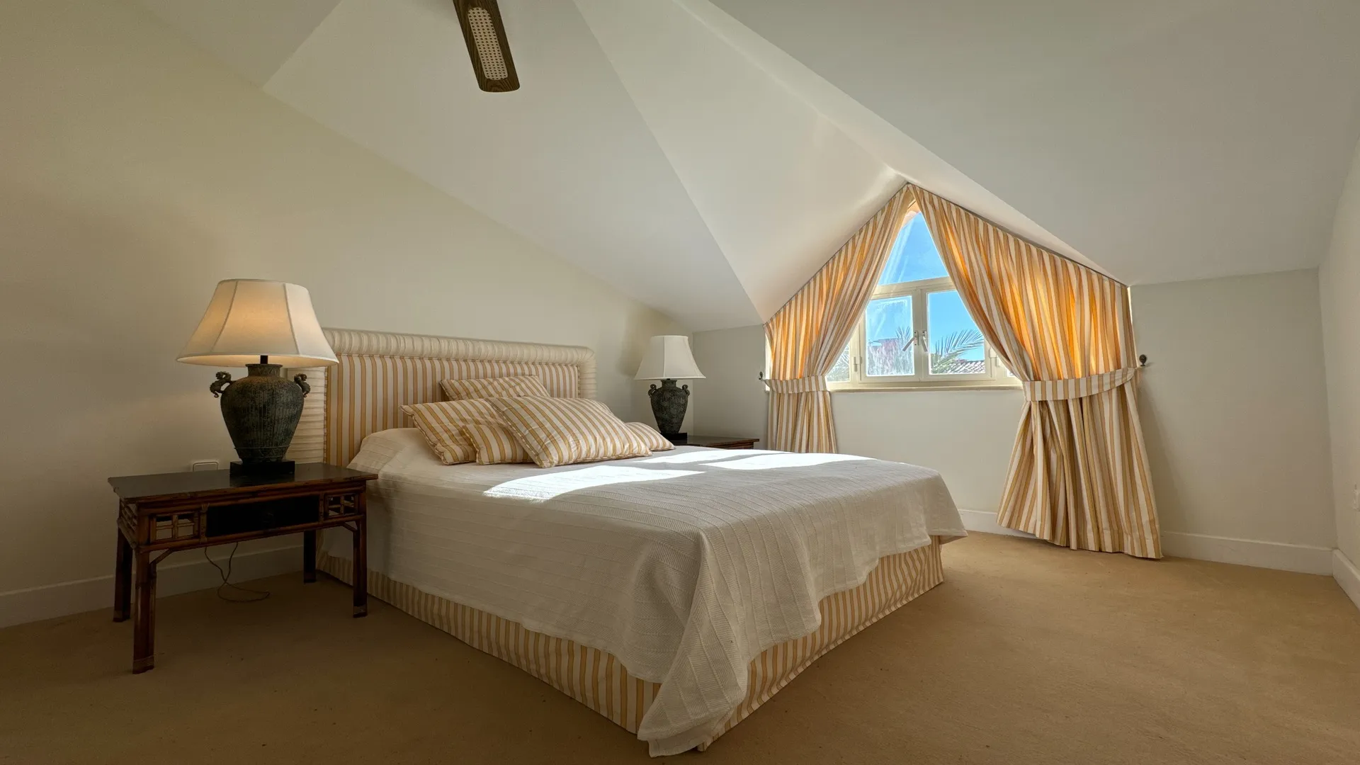 Penthouse bedroom with sloping ceiling and dormer window