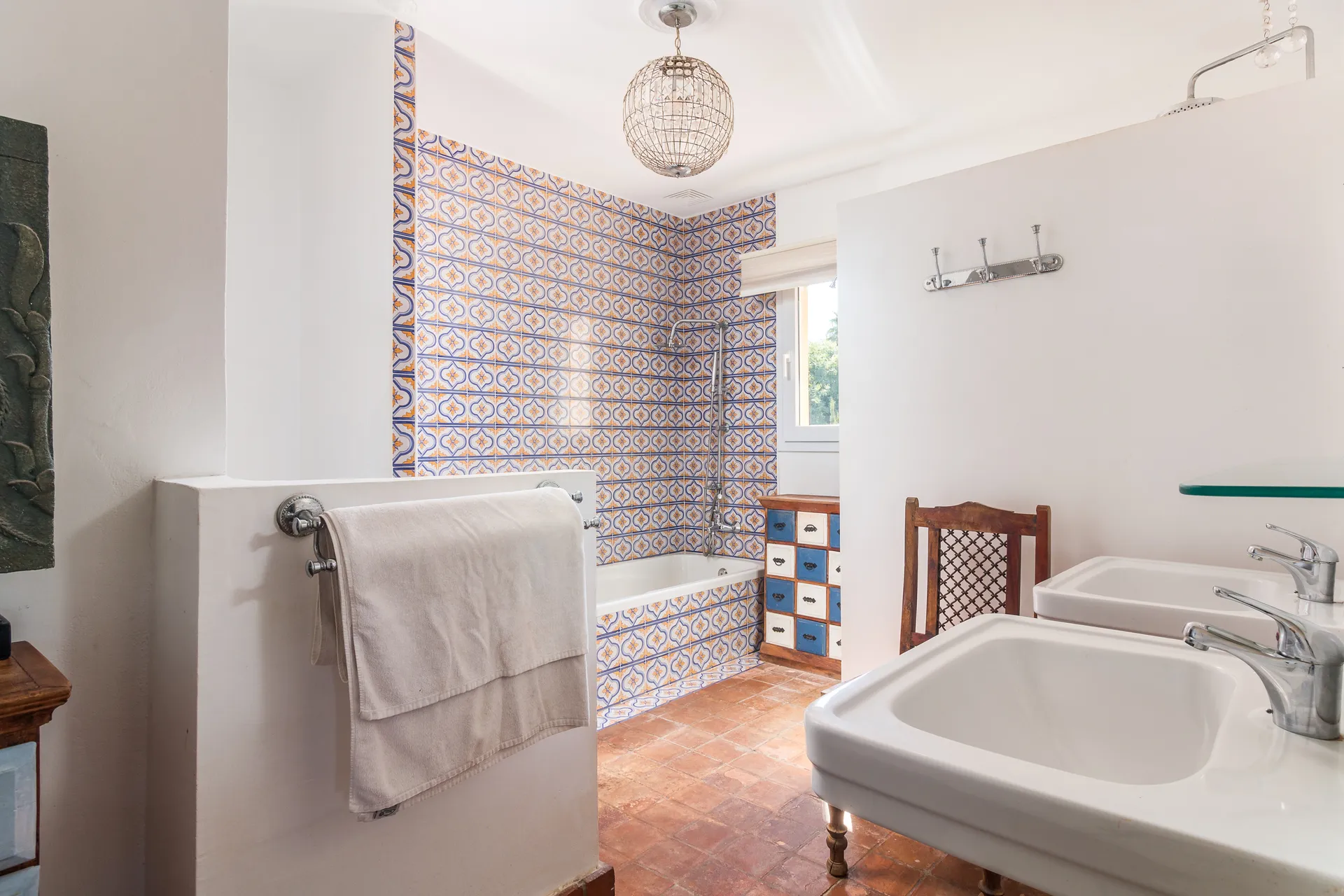 Bathroom with bathtub and tiled feature wall
