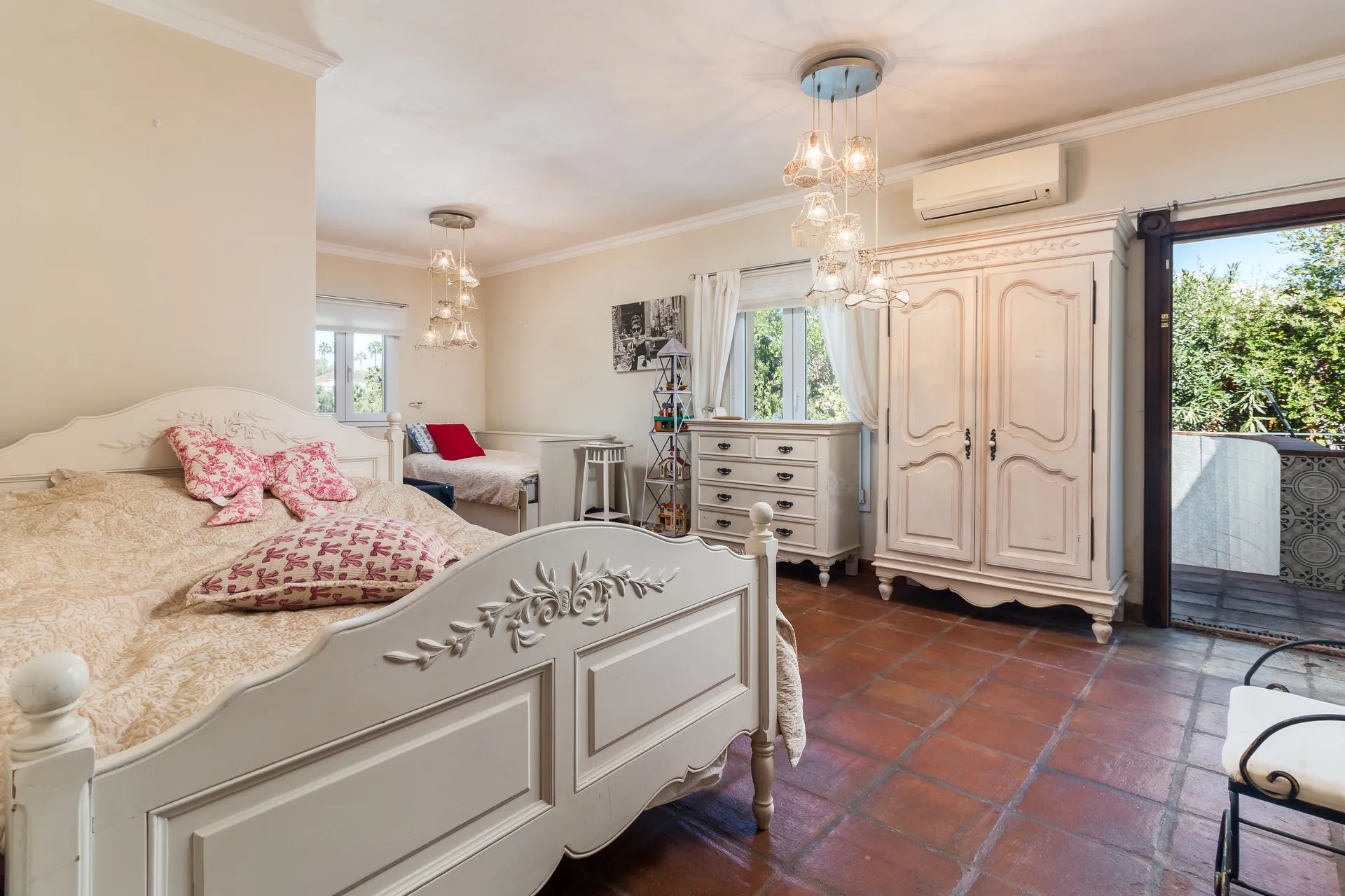 Bright bedroom with wooden flooring, fitted wardrobes and garden access