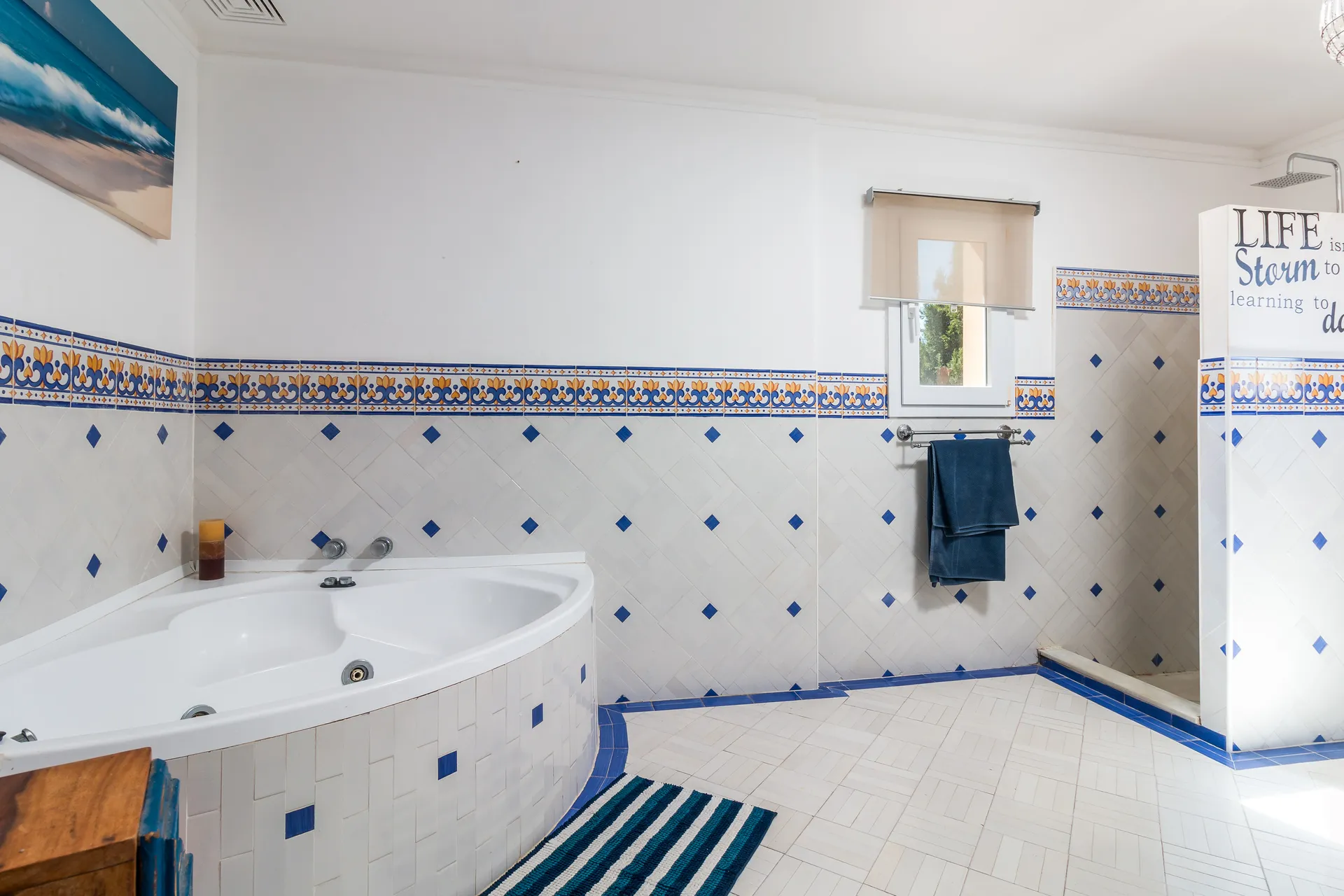 Bathroom with corner bathtub, tiled walls and separate shower