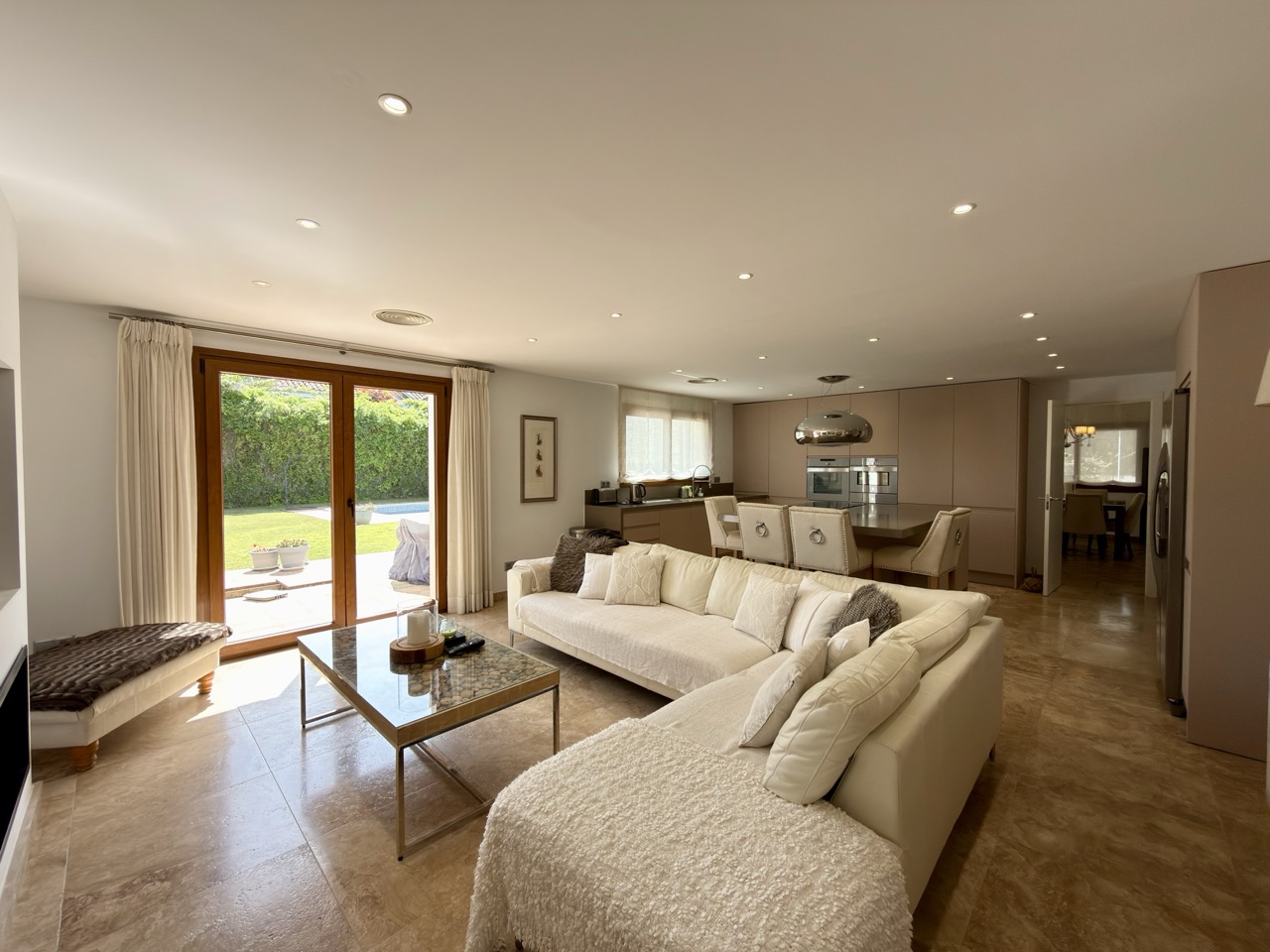 Living room with sofa seating, terrace doors and garden views