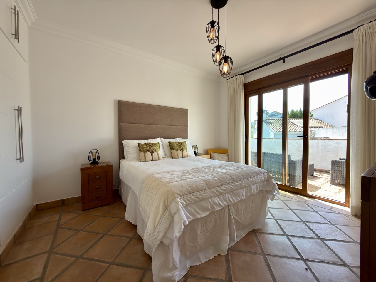 Bedroom with double bed, terrace doors and terracotta flooring