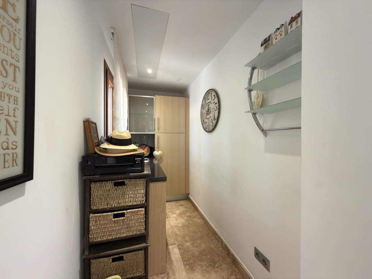 Utility area with fridge, washing machine, chest of drawers, mirror and neutral finishes