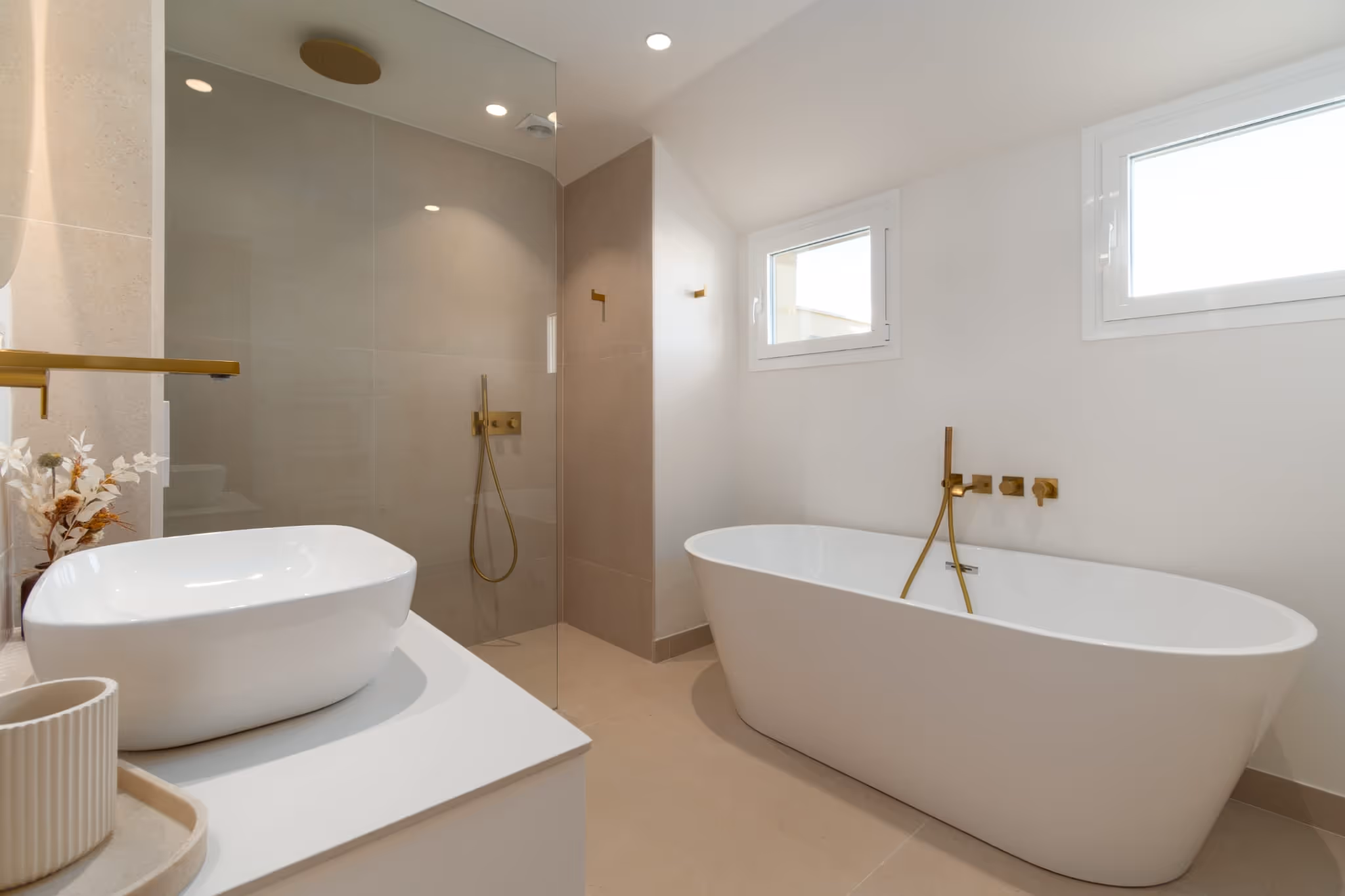 Bathroom with freestanding bathtub, walk-in shower and gold fittings