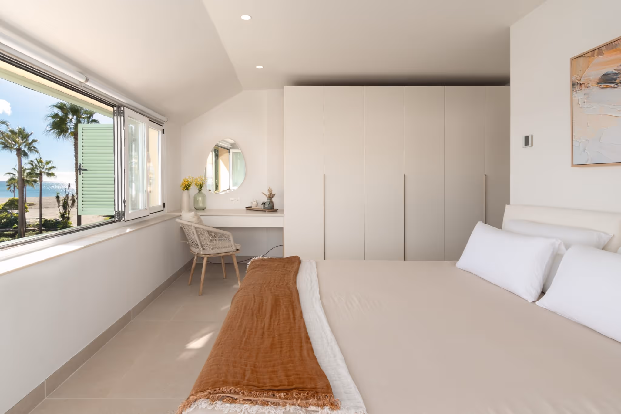 Bedroom with built-in wardrobes, desk area and natural light