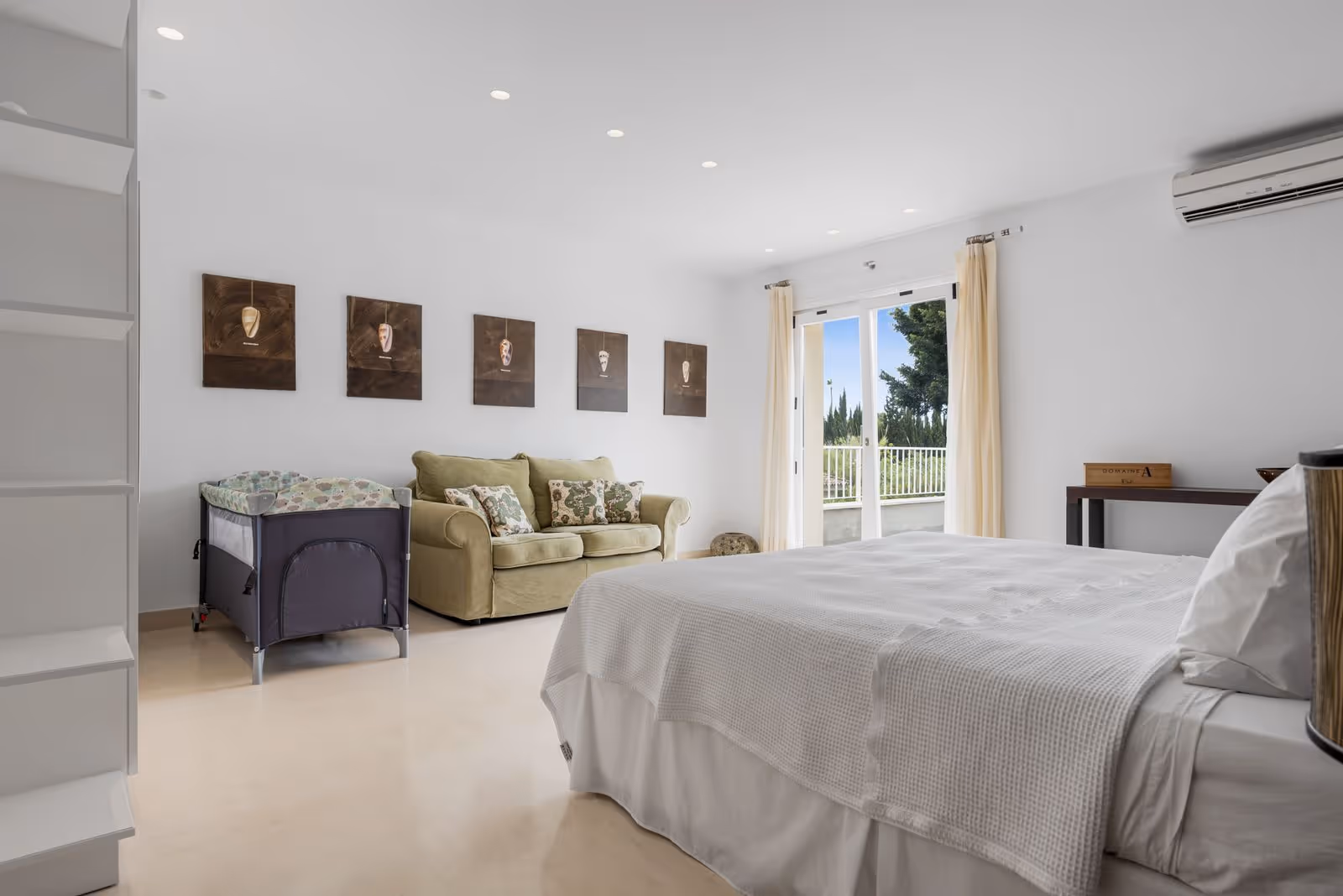 Bedroom with double bed, sofa seating and garden-facing window