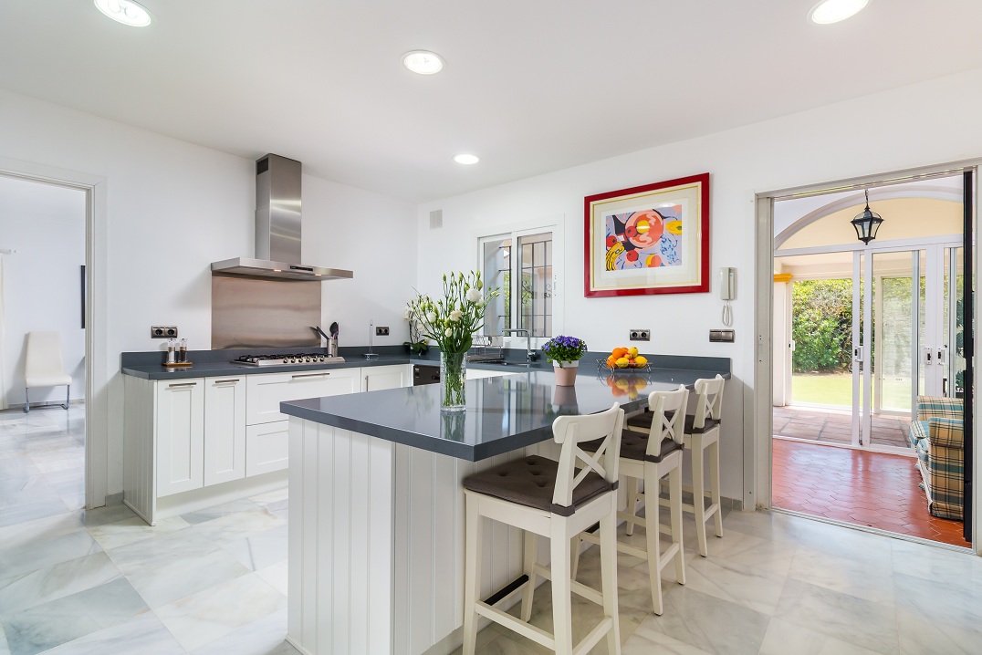 Kitchen with island, breakfast stools and garden doors