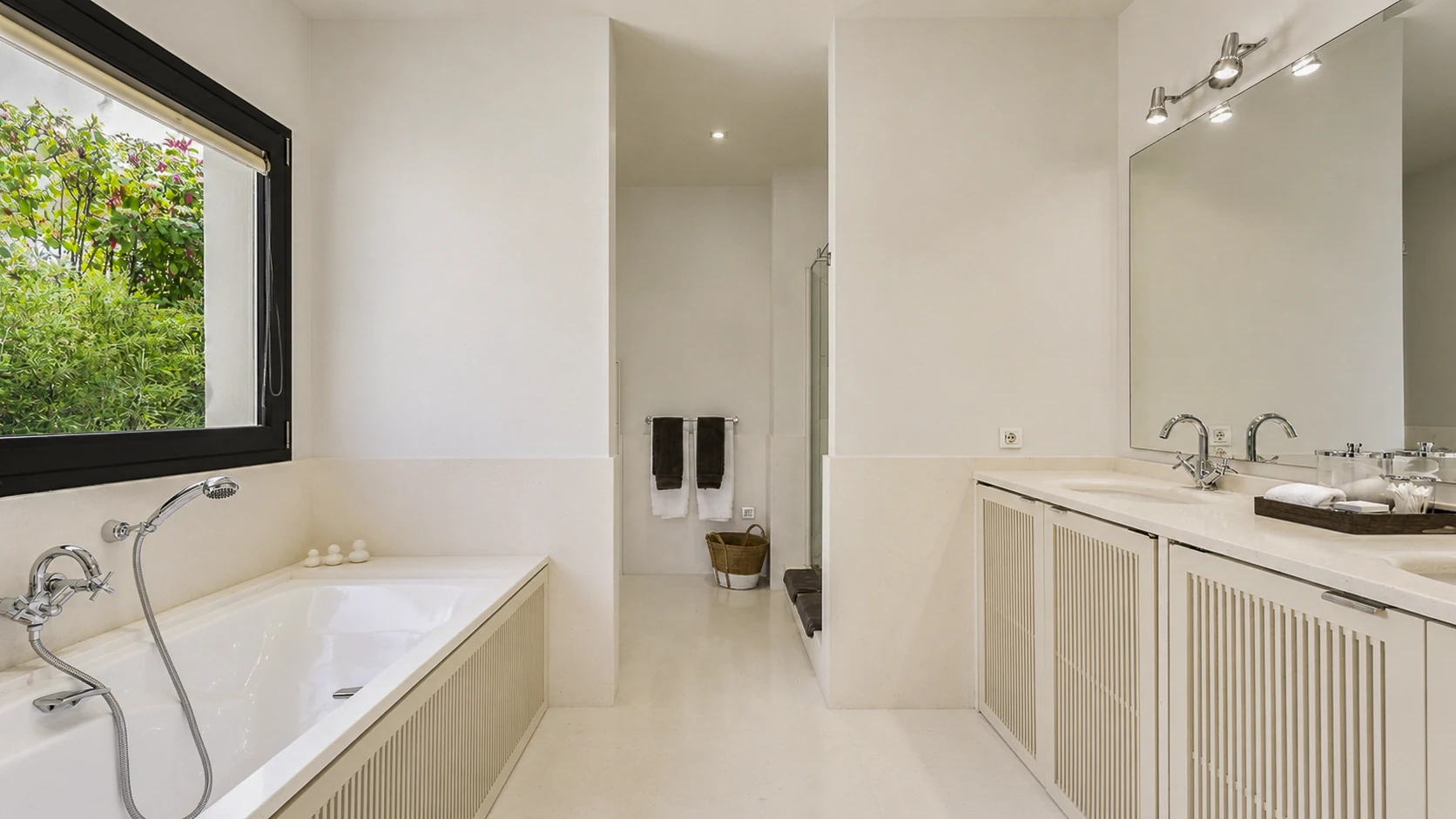 Bathroom with bath, twin basins and a separate shower