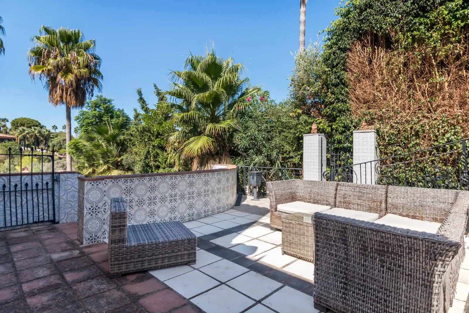 Outdoor terrace with built-in barbecue area and palm trees