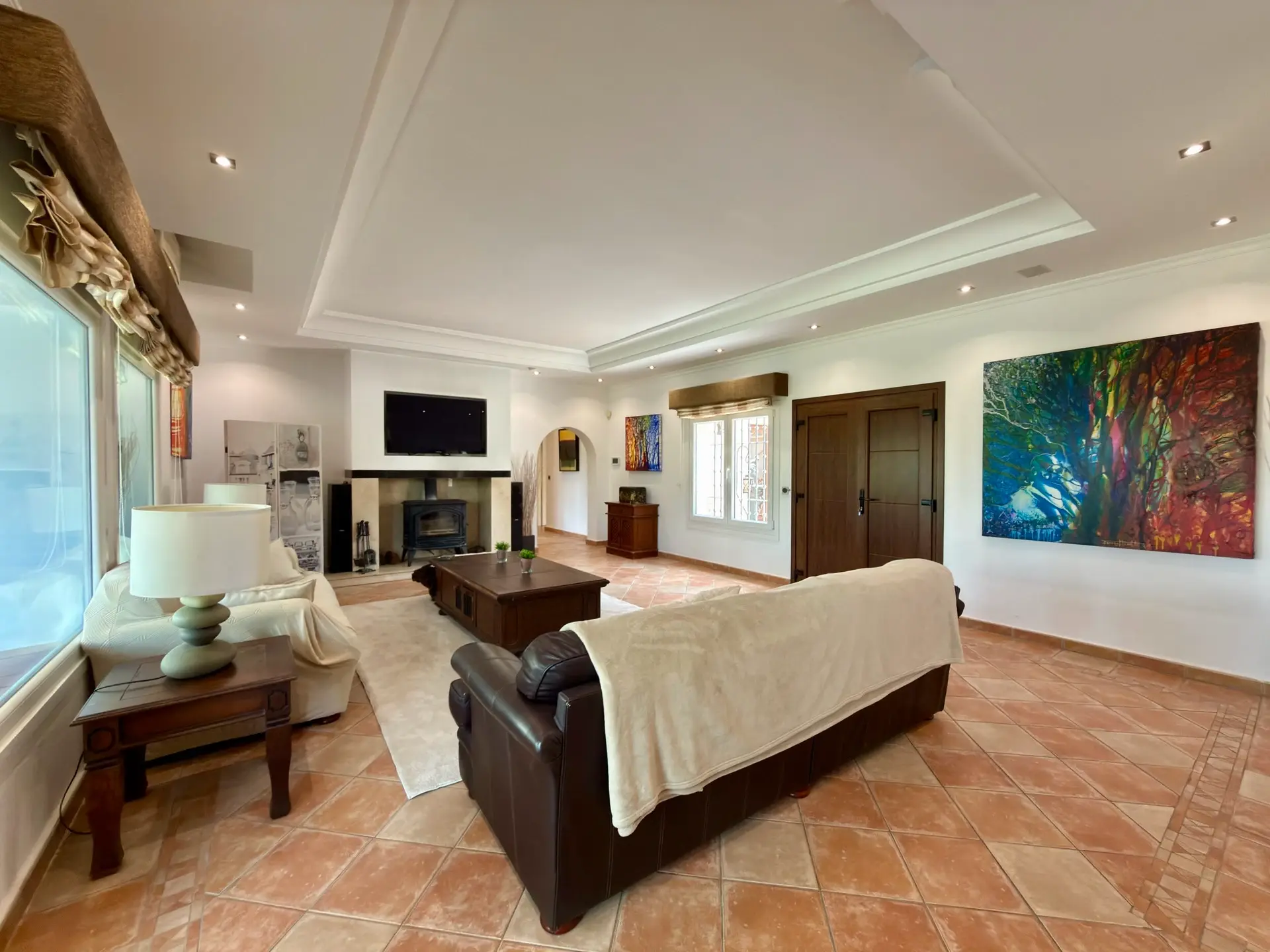 Living room with sofa seating, fireplace and garden-facing doors