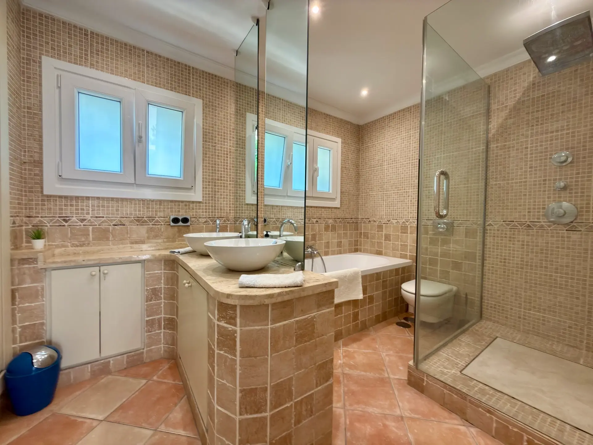 Bathroom with walk-in shower, vanity unit and tiled finishes