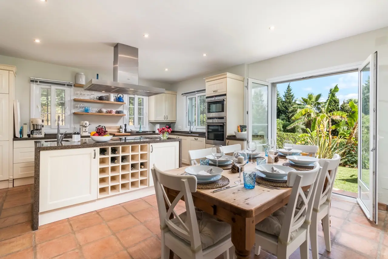 Kitchen and dining area with garden-facing doors and natural light