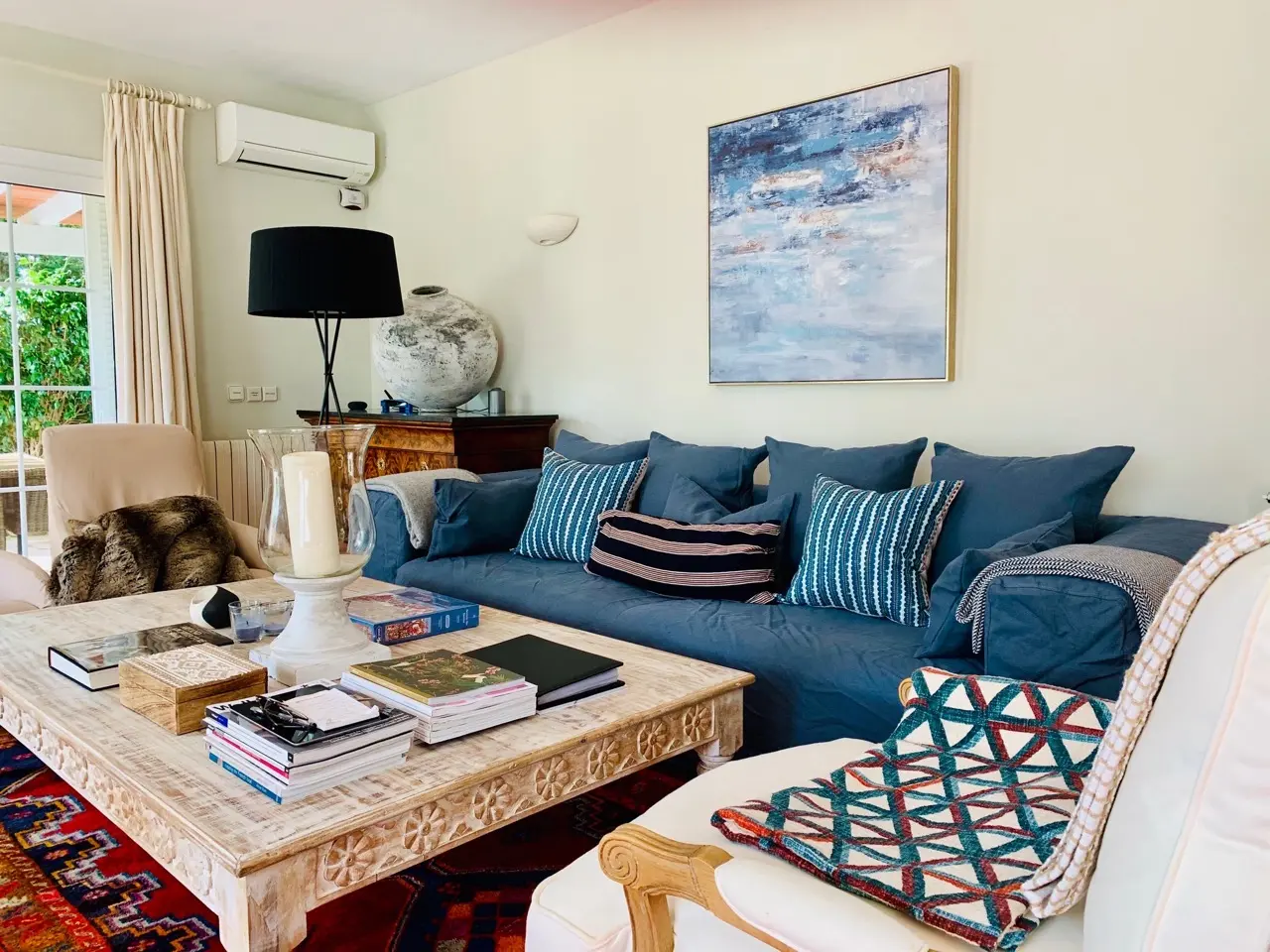 Living room with blue sofa and colourful cushions