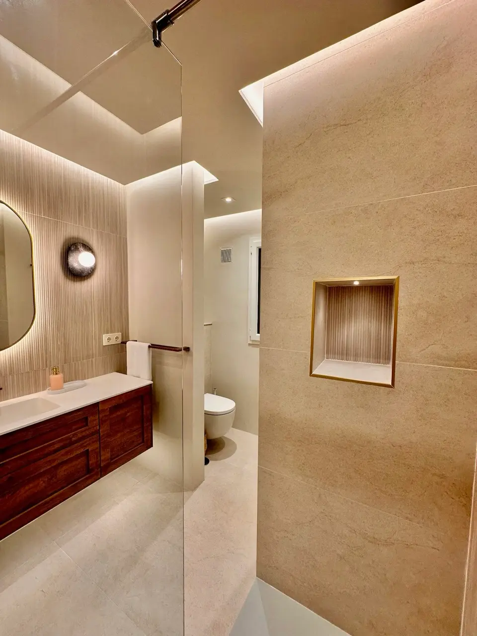 Bathroom with walk-in shower, vanity unit and warm neutral finishes