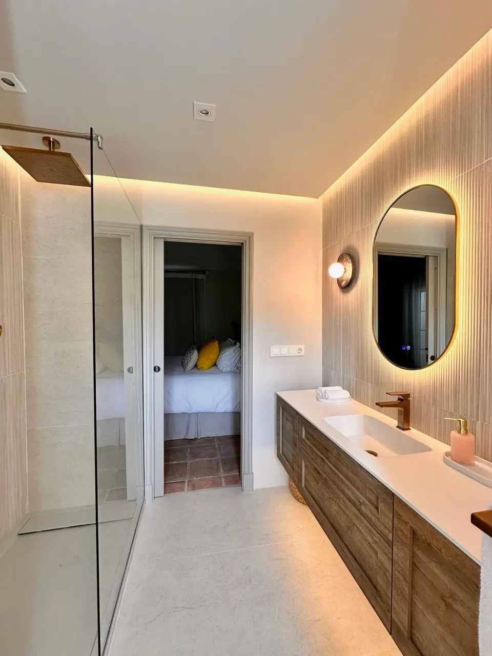 Bathroom with vanity unit, round mirror and walk-in shower