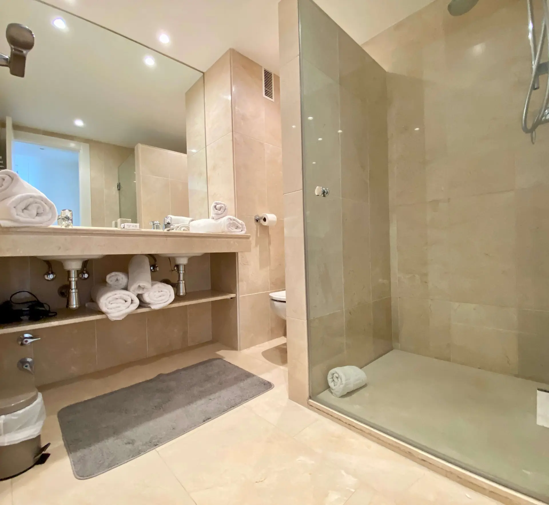 Bathroom with walk-in shower, vanity unit and recessed lighting
