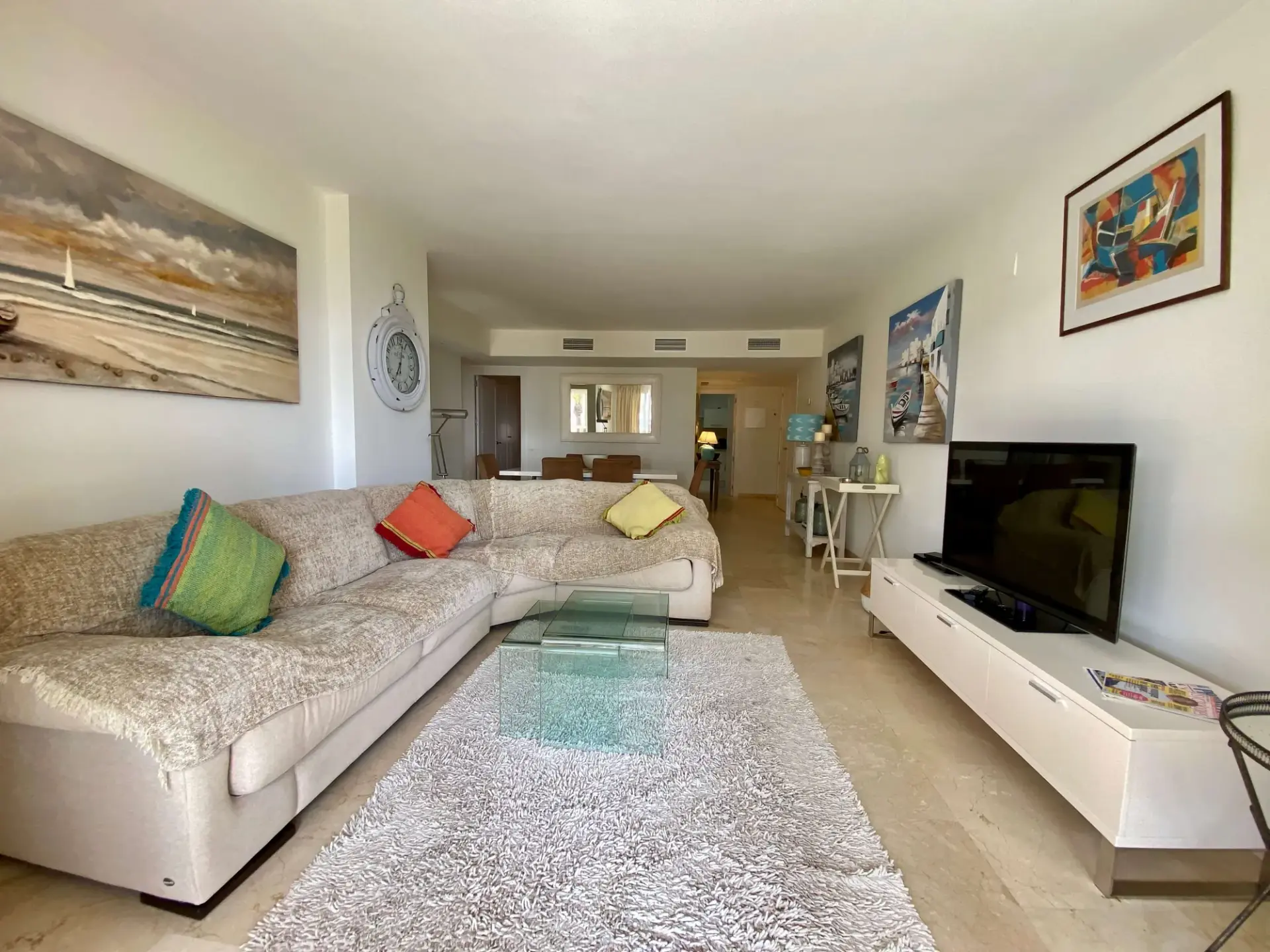 Living room with sofa seating, coffee table and TV area
