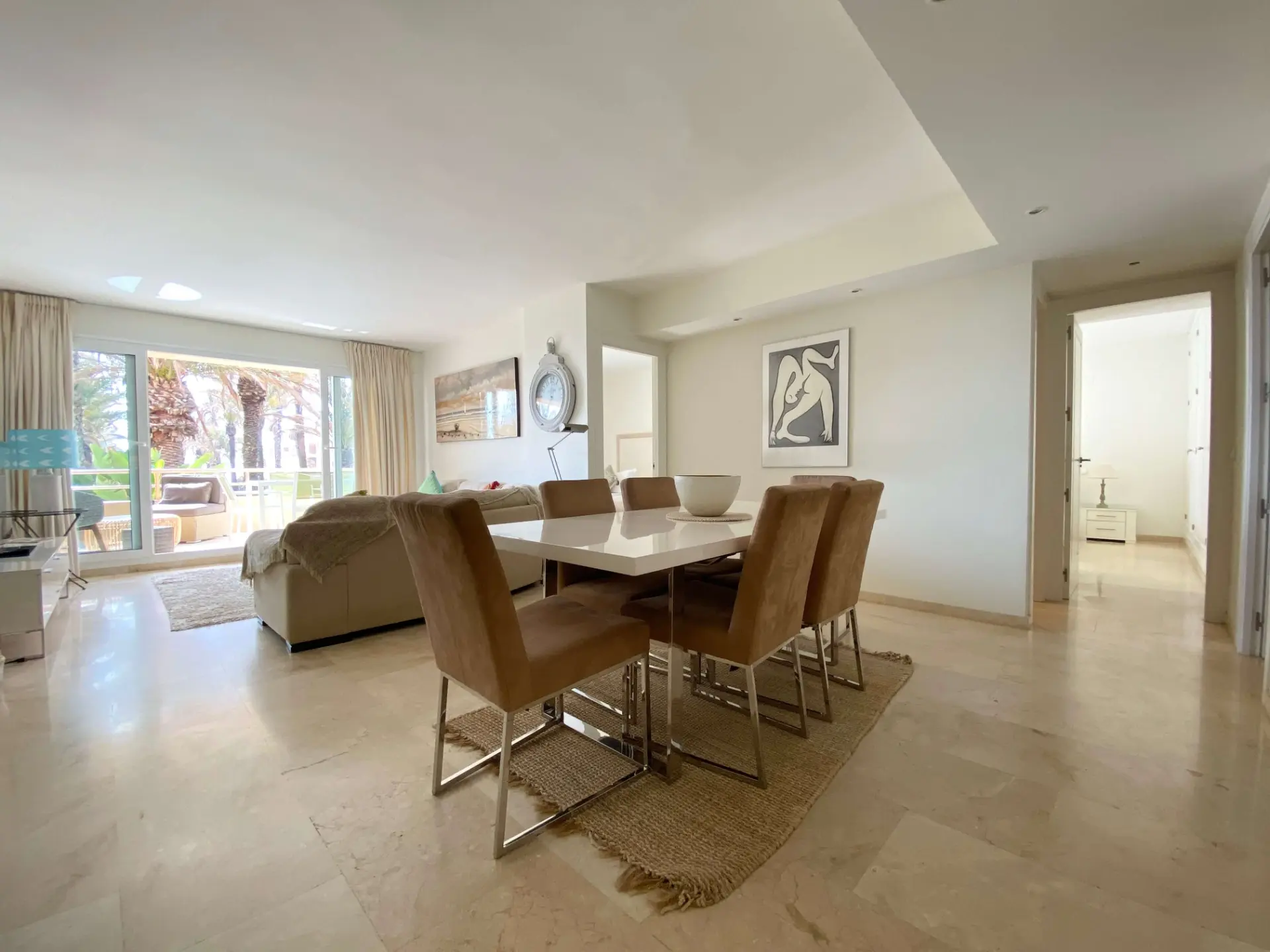 Living and dining area with terrace access and natural light