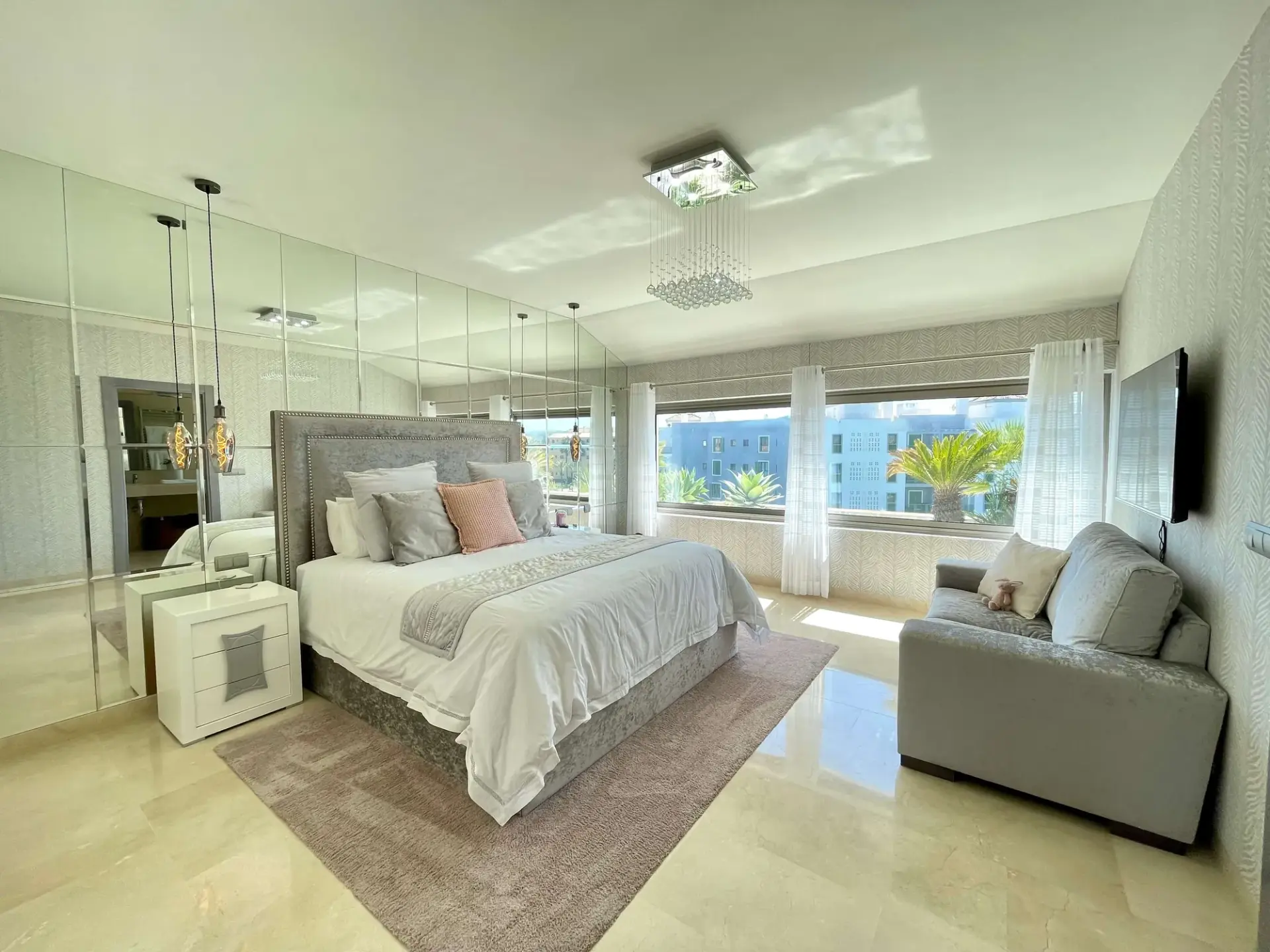 Bedroom with double bed, sofa seating and natural light