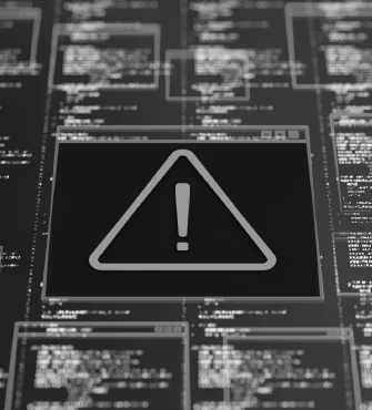 Computer screen with multiple code windows and a central warning icon showing an exclamation mark inside a triangle.
