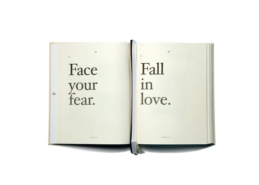 Open book with text reading 'Face your fear.' on the left page and 'Fall in love.' on the right page.