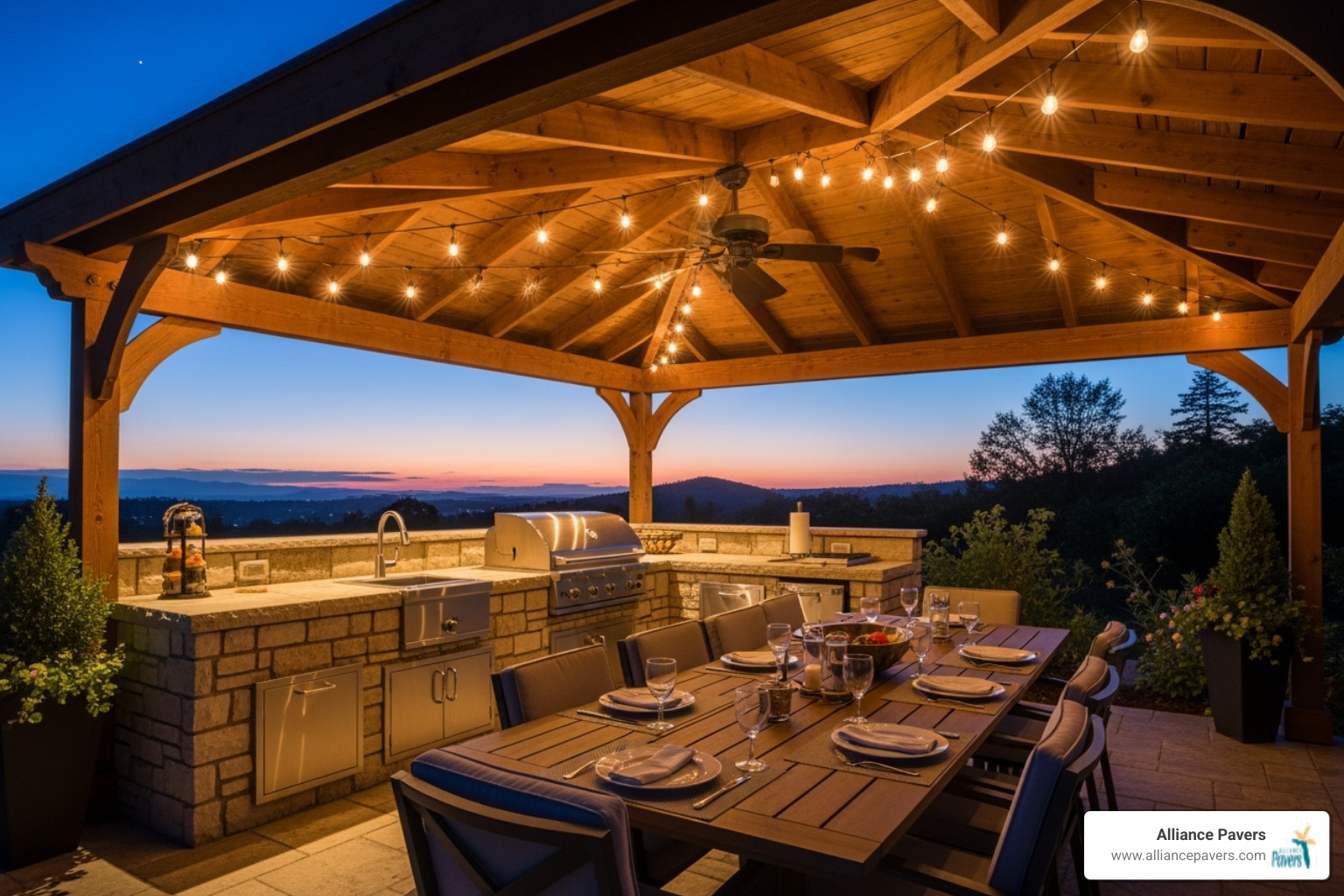 outdoor kitchen and dining area under a pergola, illuminated by string lights at dusk - extra outdoor room