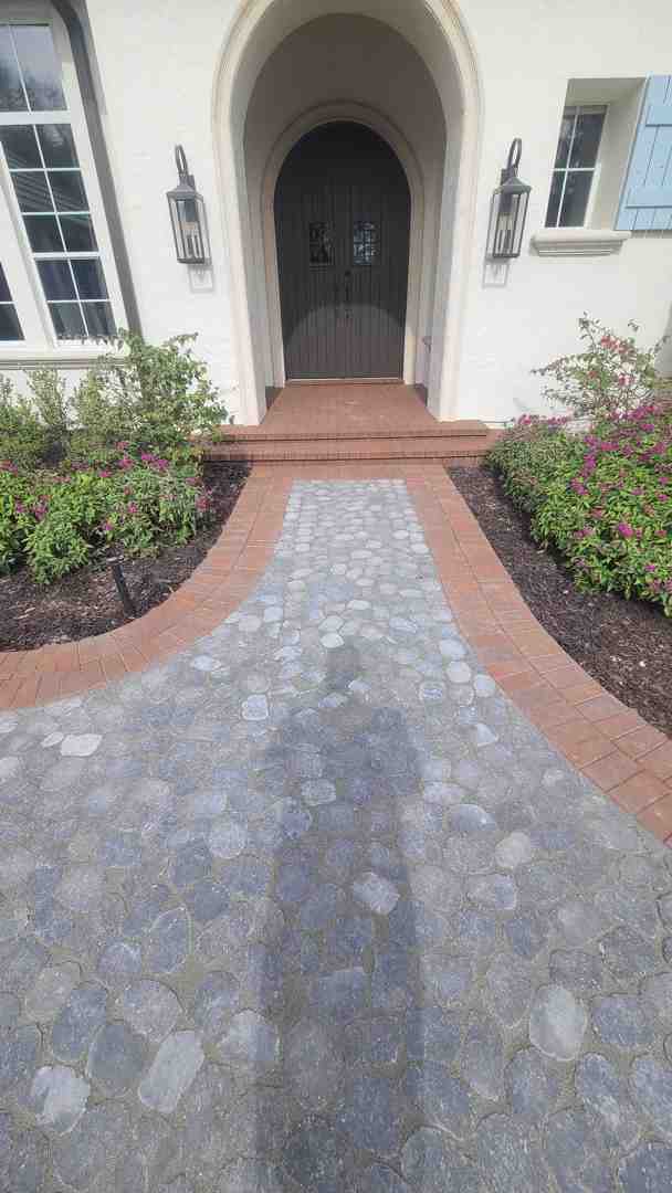 Image of a winding garden path with classic brick paver edging - edge flower bed ideas